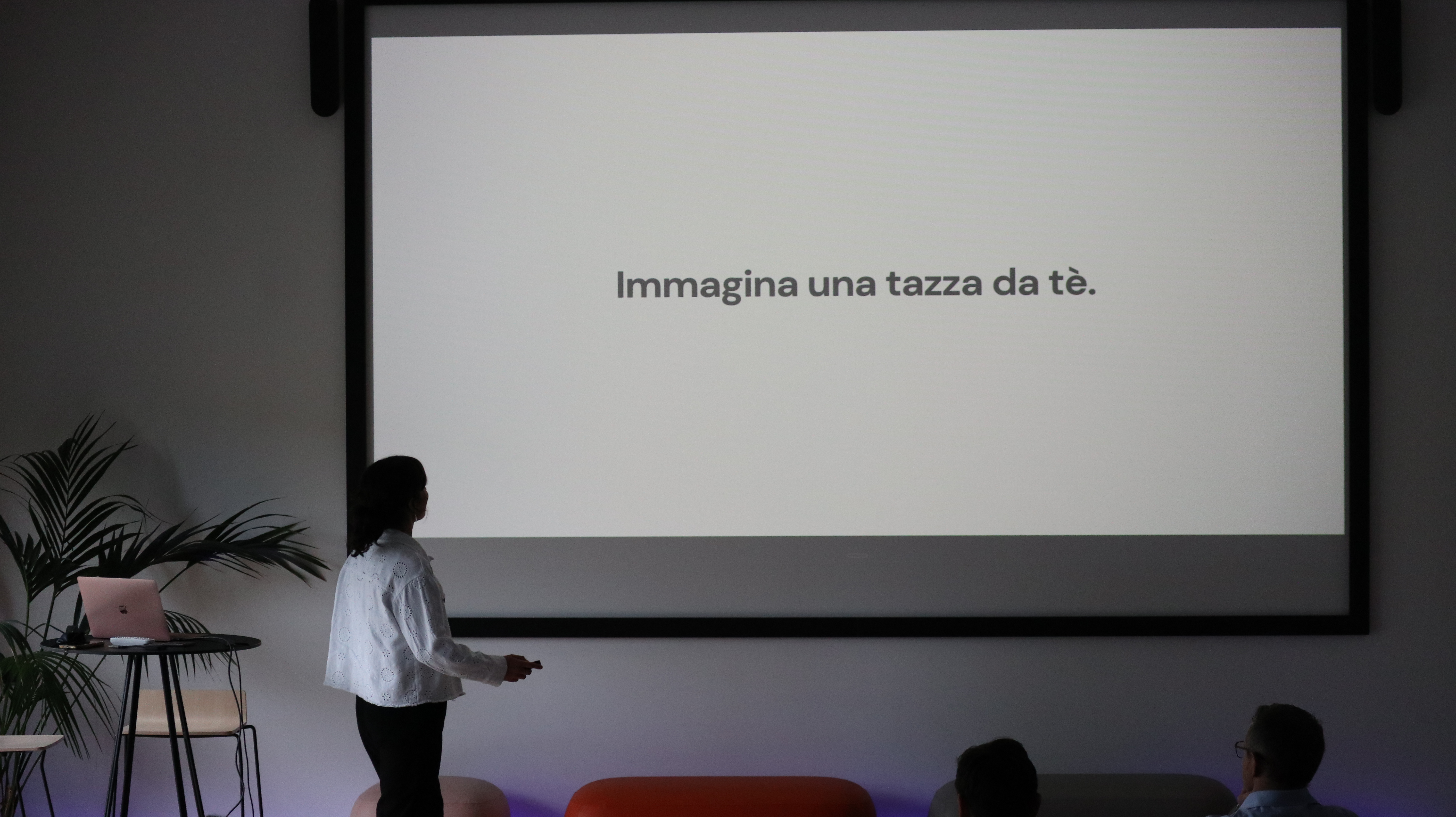 Isabella speaking at a tech community event